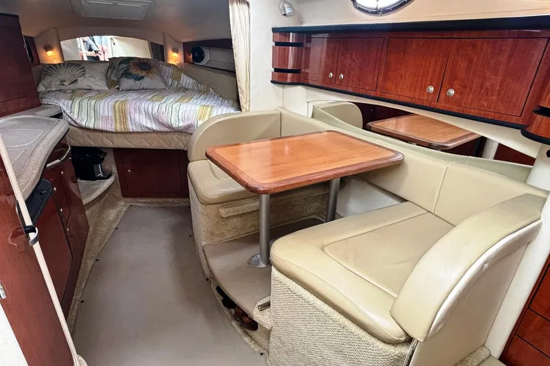 Slide: The Image of Interior of 2006 Sea Ray 300 Sundancer with cozy seating and sleeping area. - 17
