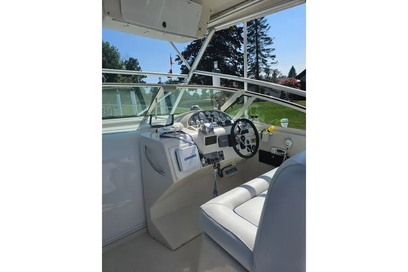 Slide: The Image of 1998 Pro-Line 3250 Express boat cockpit with steering wheel and navigation equipment. - 5