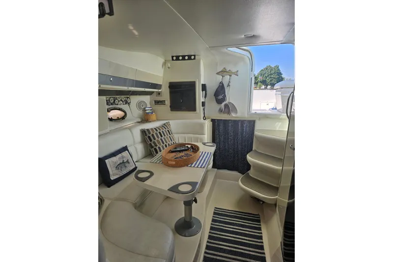 Slide: The Image of Interior of 1998 Pro-Line 3250 Express boat with cozy seating and nautical decor. - 6