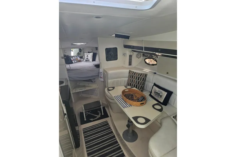 Slide: The Image of Interior of 1998 Pro-Line 3250 Express boat with cozy seating and nautical decor. - 7