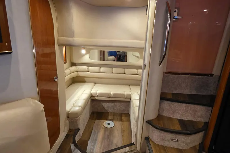 Slide: The Image of 1998 Sea Ray Sundancer 400 interior with beige seating and wooden accents. - 10