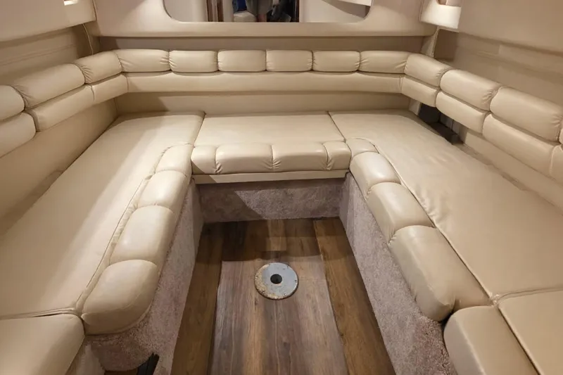 Slide: The Image of Interior of 1998 Sea Ray Sundancer 400 with beige leather seating and wood flooring. - 11