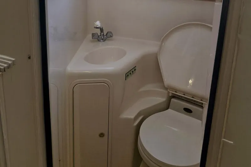 Slide: The Image of Compact bathroom in 1998 Sea Ray Sundancer 400 yacht with sink and toilet. - 13