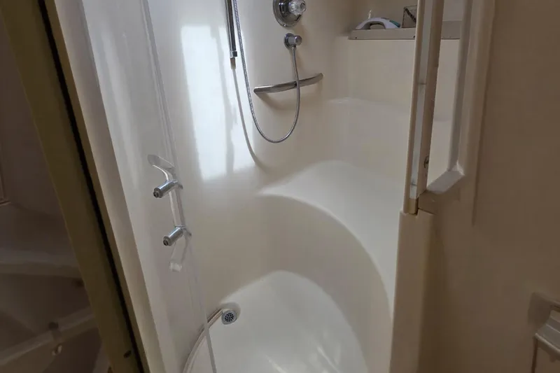 Slide: The Image of Shower area inside 1998 Sea Ray Sundancer 400 yacht, featuring sleek design and fixtures. - 14