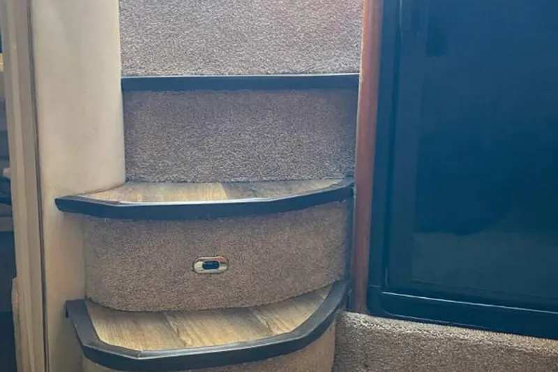 Slide: The Image of Carpeted stairs inside a 1998 Sea Ray Sundancer 400 yacht. - 15