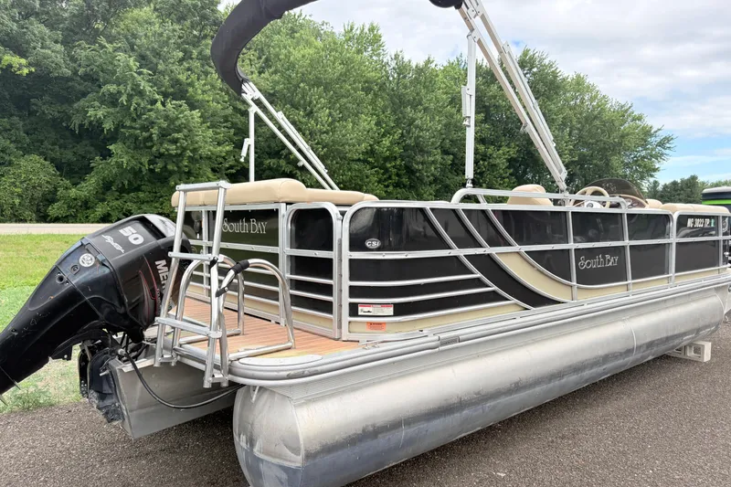 Slide: The Image of 2013 South Bay 522CR pontoon boat with Mercury 50 engine, parked on a road. - 1