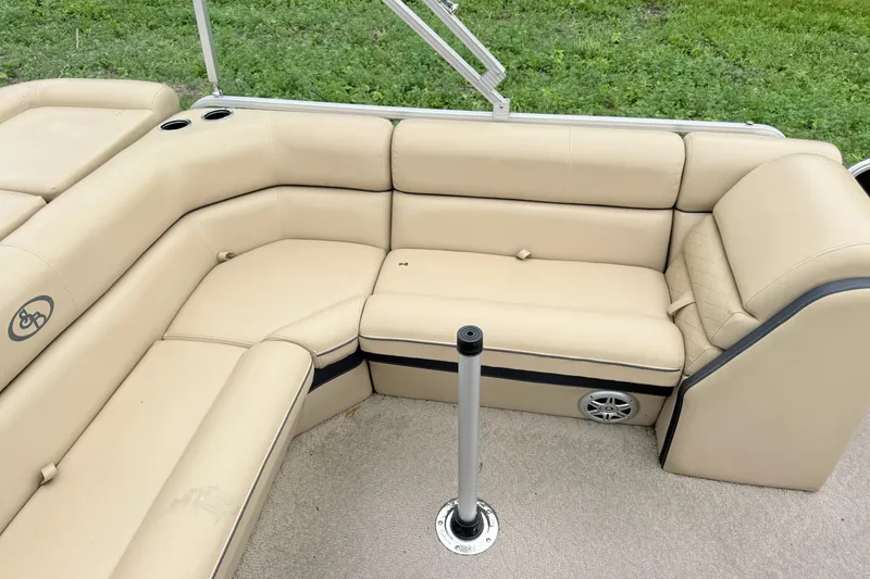 Slide: The Image of 2013 South Bay 522CR boat interior with beige seating and cup holders. - 6