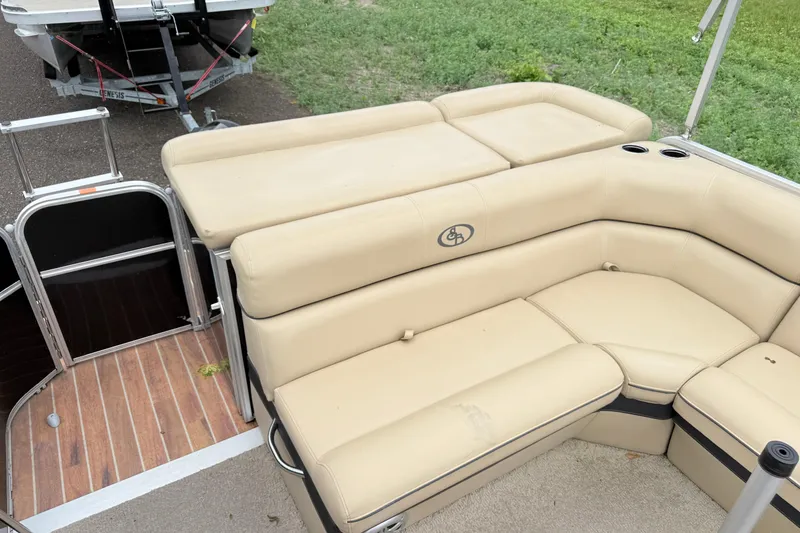 Slide: The Image of 2013 South Bay 522CR pontoon boat with beige seating and cup holders. - 7