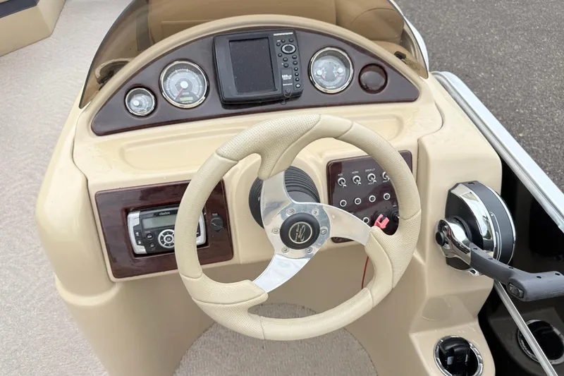 Slide: The Image of Steering console of a 2013 South Bay 522CR boat with gauges and controls. - 8