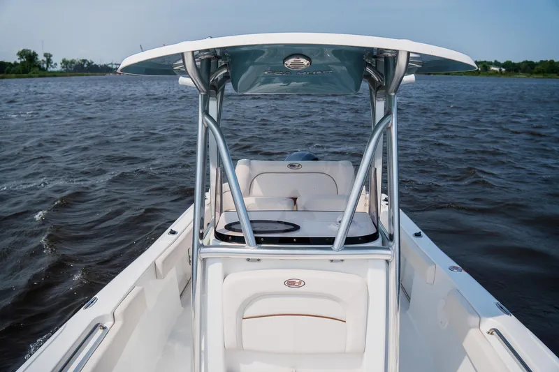 Slide: The Image of 2022 Sea Hunt Ultra 229 boat on water, featuring sleek design and spacious seating. - 10