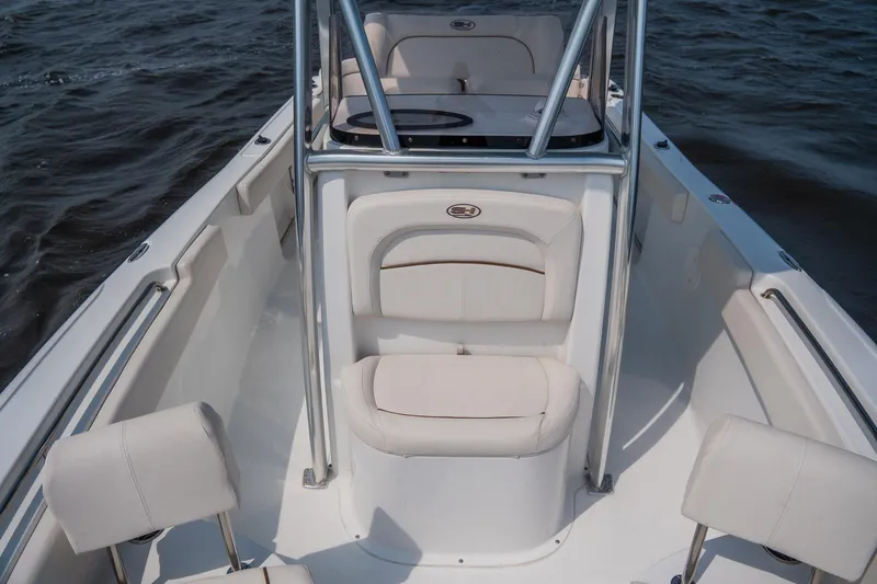 Slide: The Image of 2022 Sea Hunt Ultra 229 boat interior with white seating on open water. - 11