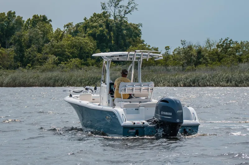 Slide: The Image of 2022 Sea Hunt Ultra 229 boat cruising on a lake with Yamaha engine. - 4