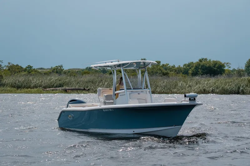 The Image of 2022 Sea Hunt Ultra 229 boat cruising on a scenic waterway. - 0