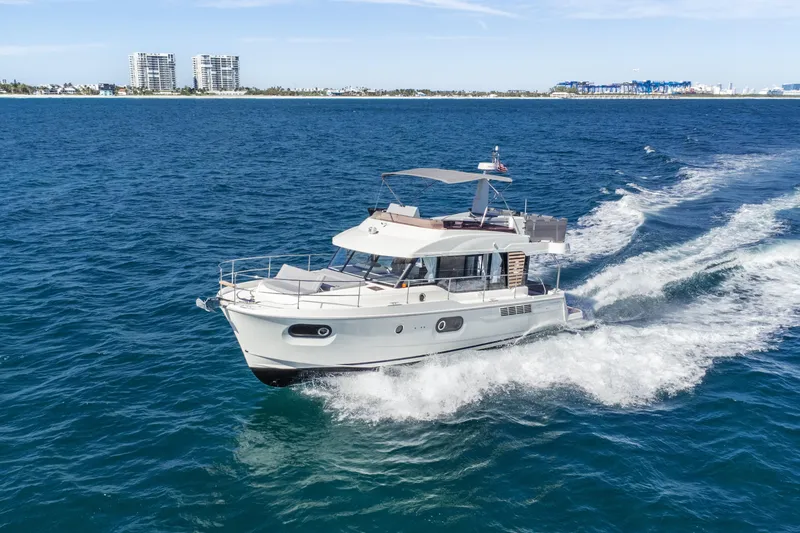 Slide: The Image of 2025 Beneteau Swift Trawler 41 Fly cruising on open blue sea. - 1