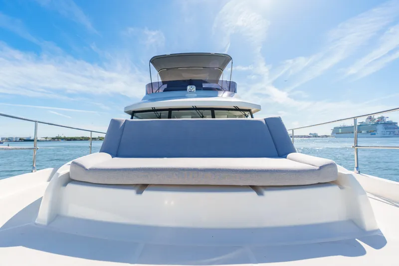 Slide: The Image of 2025 Beneteau Swift Trawler 41 Fly on open water, featuring spacious deck seating. - 15