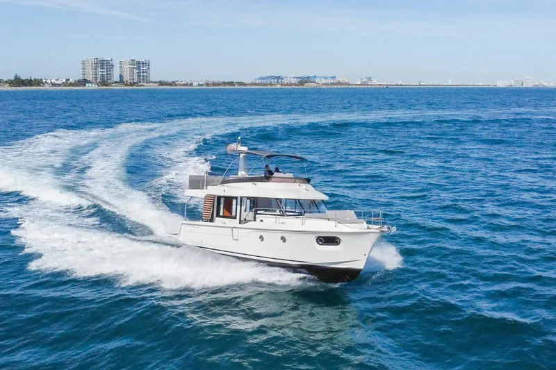Slide: The Image of 2025 Beneteau Swift Trawler 41 Fly cruising on open blue waters. - 2