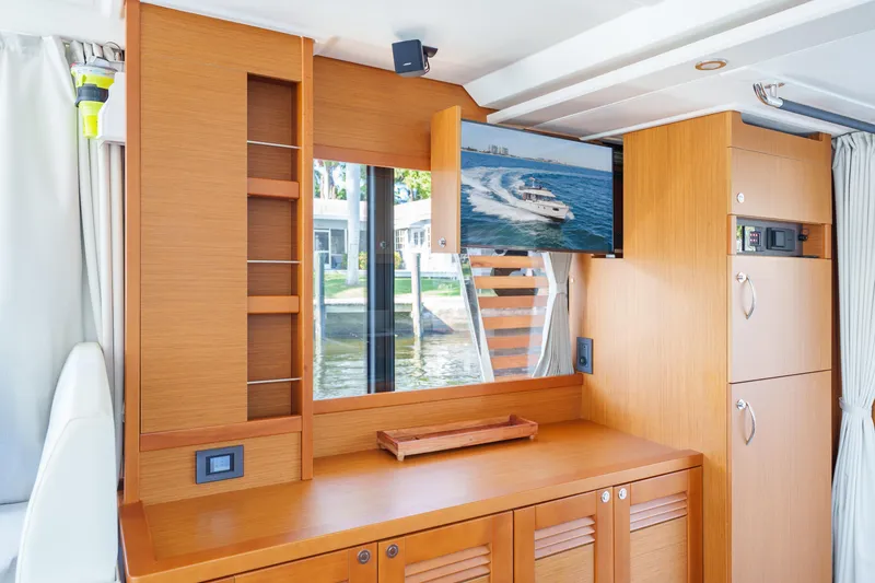 Slide: The Image of Interior of 2025 Beneteau Swift Trawler 41 Fly with wood cabinetry and mounted TV. - 25