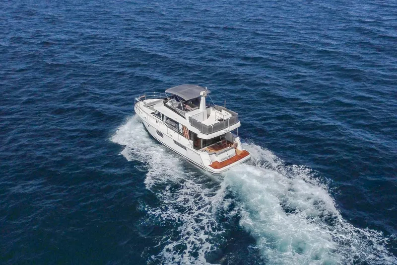 Slide: The Image of 2025 Beneteau Swift Trawler 41 Fly cruising on open sea. - 3