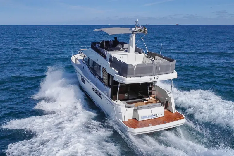 Slide: The Image of 2025 Beneteau Swift Trawler 41 Fly cruising on open sea, rear view. - 5