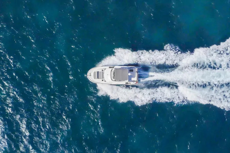 Slide: The Image of Aerial view of 2025 Beneteau Swift Trawler 41 Fly cruising on open water. - 7
