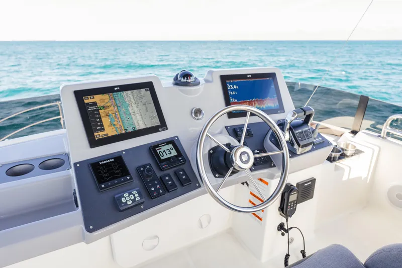 Slide: The Image of 2025 Beneteau Swift Trawler 41 Fly helm with navigation screens and steering wheel. - 8