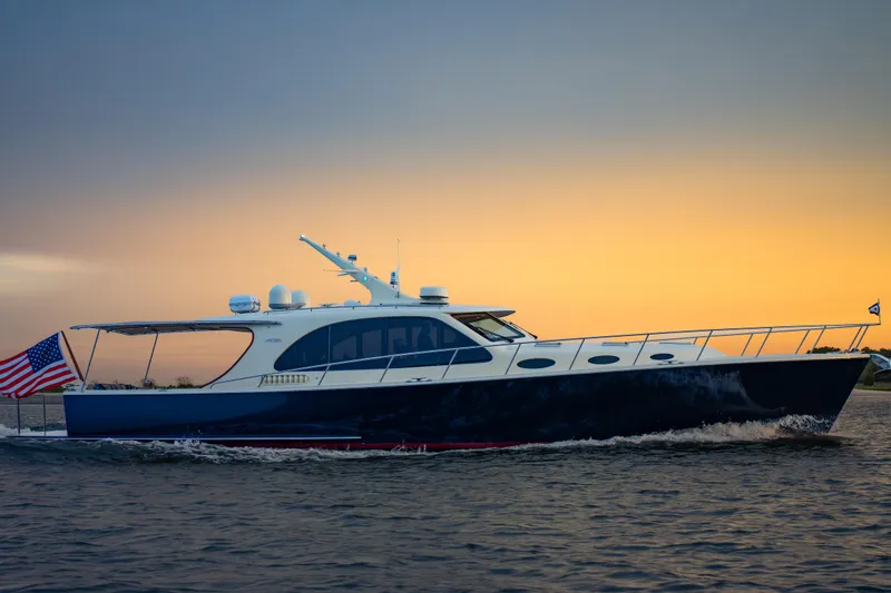 Slide: The Image of 2018 Palm Beach Motor Yachts 55 cruising at sunset with American flag. - 1