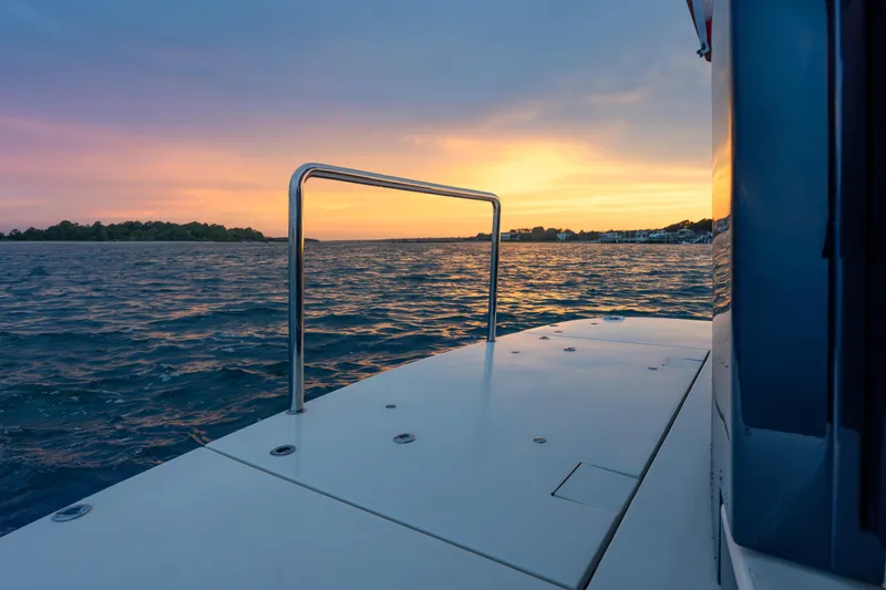Slide: The Image of 2018 Palm Beach Motor Yachts 55 at sunset on tranquil waters. - 14