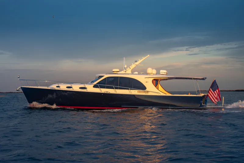 Slide: The Image of 2018 Palm Beach Motor Yachts 55 cruising on open water at sunset. - 5