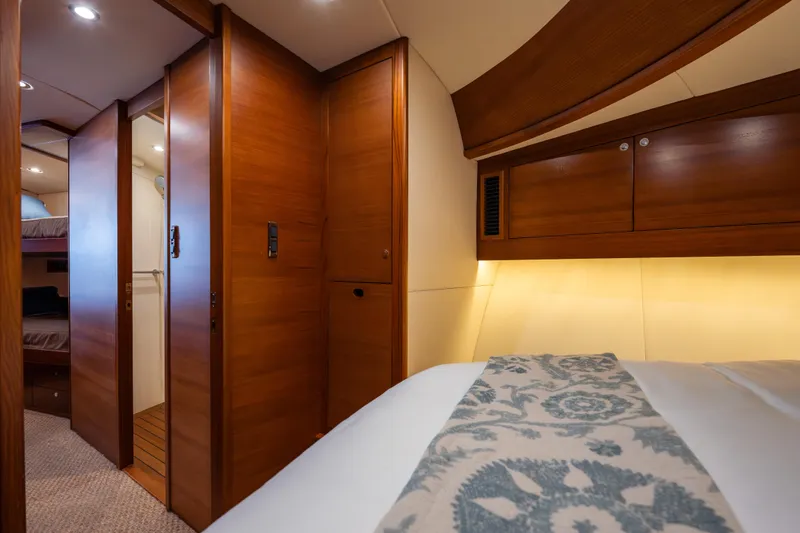 Slide: The Image of Luxurious interior of 2018 Palm Beach Motor Yachts 55, featuring elegant wood finishes and cozy lighting. - 26