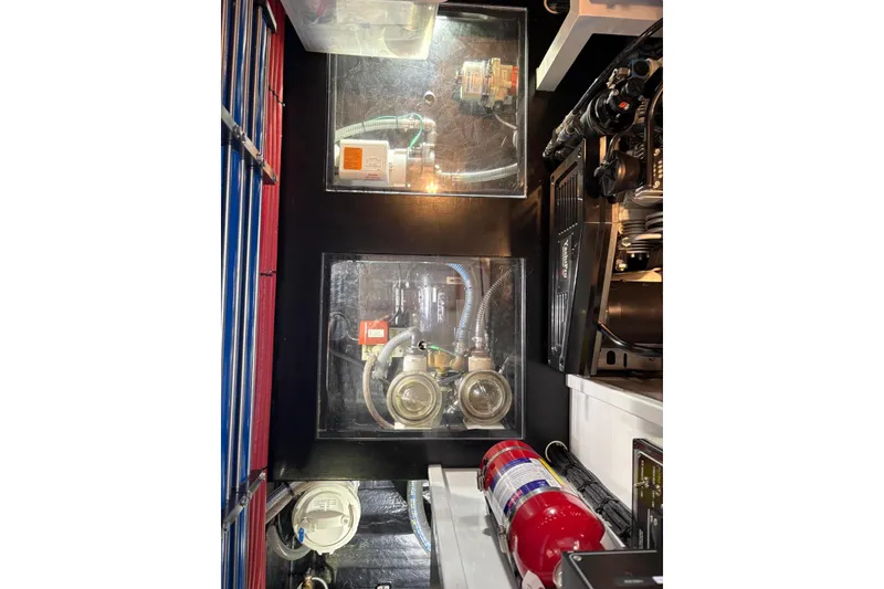 Slide: The Image of Engine room of 2018 Palm Beach Motor Yachts 55, showcasing mechanical components and fire extinguisher. - 45