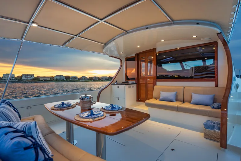 Slide: The Image of Luxurious 2018 Palm Beach Motor Yachts 55 interior with elegant seating and sunset view. - 13