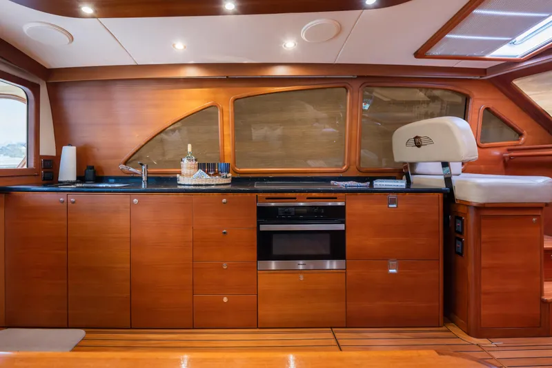 Slide: The Image of Luxurious interior of 2018 Palm Beach Motor Yachts 55 with elegant wood cabinetry and modern appliances. - 17