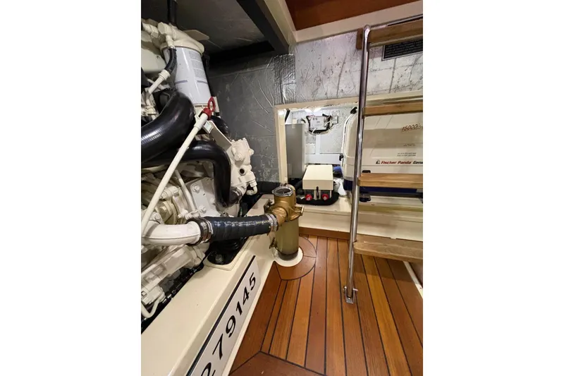 Slide: The Image of Engine room of 2018 Palm Beach Motor Yachts 55, featuring mechanical components and wooden flooring. - 38