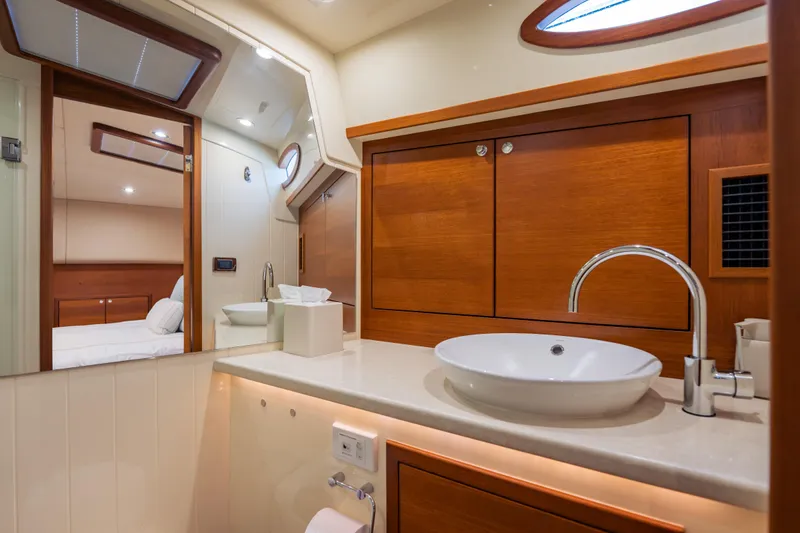 Slide: The Image of Luxurious bathroom interior of 2018 Palm Beach Motor Yachts 55, featuring modern sink and wood accents. - 32