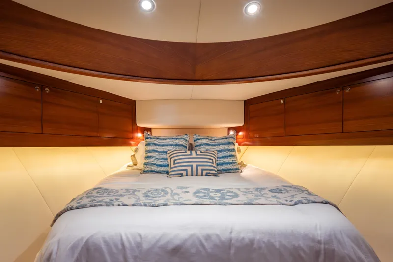 Slide: The Image of Luxurious cabin interior of 2018 Palm Beach Motor Yachts 55 with elegant bedding and wood finish. - 23