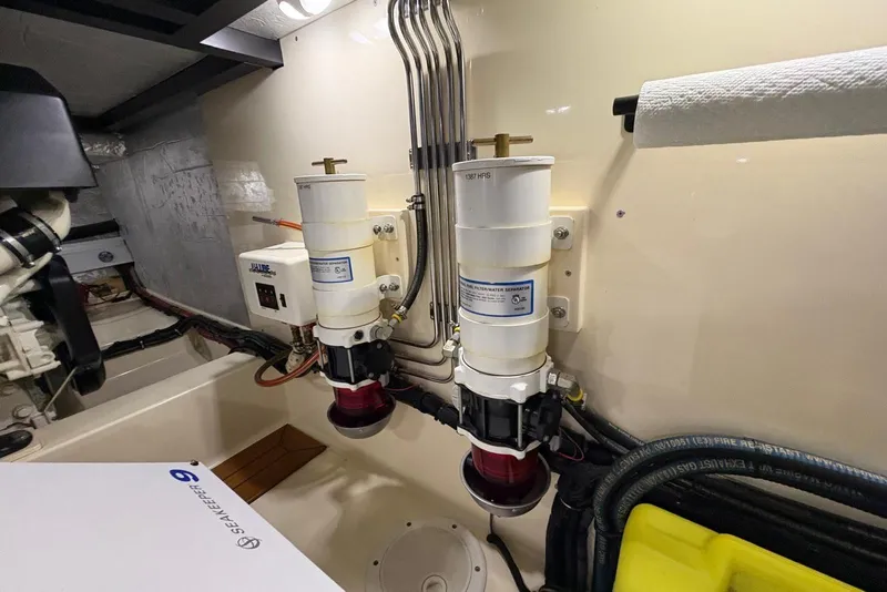Slide: The Image of Engine room of 2018 Palm Beach Motor Yachts 55, featuring fuel filters and Seakeeper stabilizer. - 42