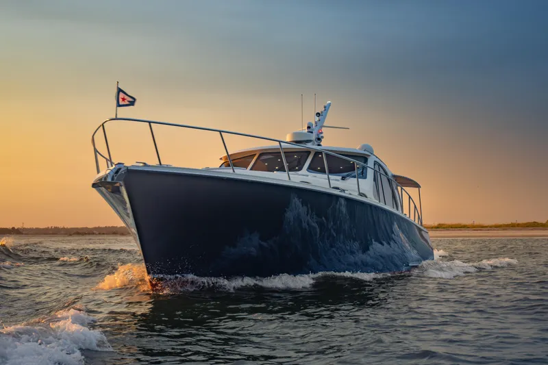 Slide: The Image of 2018 Palm Beach Motor Yachts 55 cruising at sunset on open water. - 4