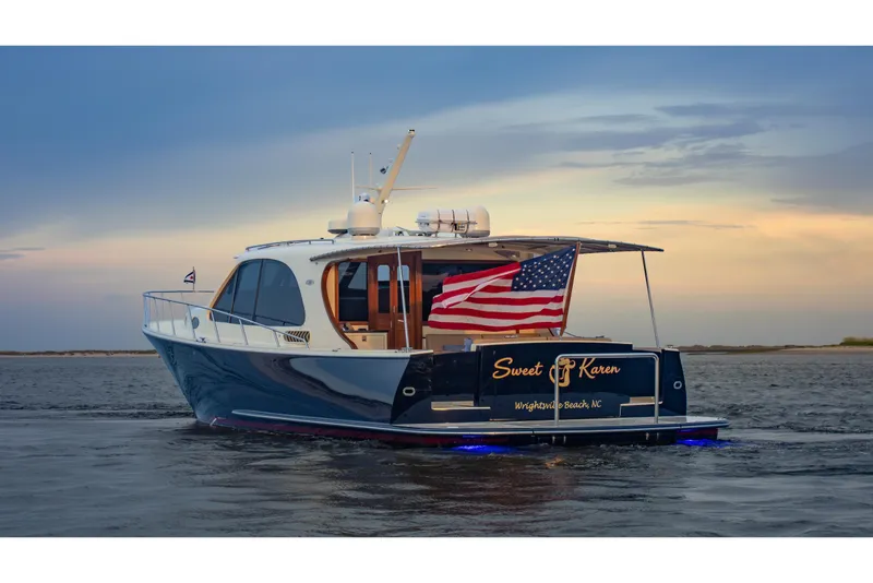 Slide: The Image of 2018 Palm Beach Motor Yachts 55 cruising at sunset with American flag displayed. - 8