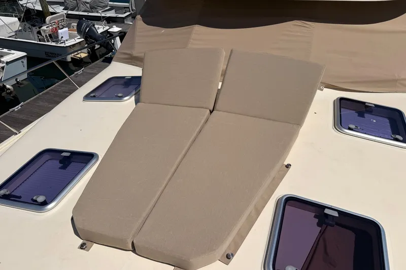 Slide: The Image of Sunbathing cushions on 2018 Palm Beach Motor Yachts 55 deck, surrounded by hatches. - 16