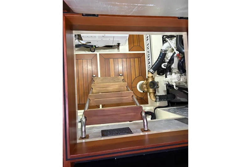 Slide: The Image of Engine room of 2018 Palm Beach Motor Yachts 55, featuring wooden steps and mechanical components. - 36