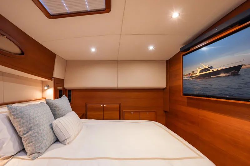 Slide: The Image of Luxurious cabin interior of 2018 Palm Beach Motor Yachts 55, featuring elegant wood finishes and cozy bedding. - 30