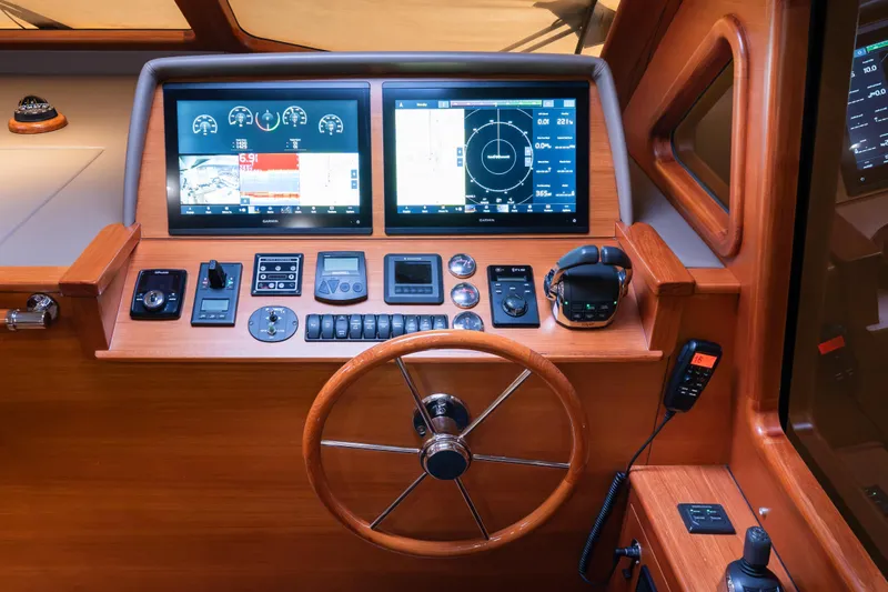 Slide: The Image of Cockpit of 2018 Palm Beach Motor Yachts 55 with advanced navigation displays and controls. - 21