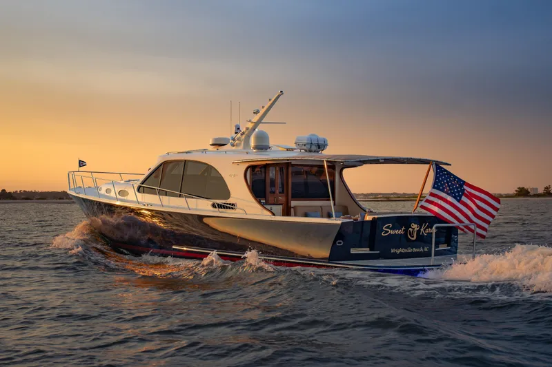 Slide: The Image of 2018 Palm Beach Motor Yachts 55 cruising at sunset with American flag. - 7