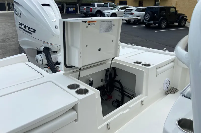 Slide: The Image of 2027 Regulator 26XO boat with Yamaha XTO V8 engine, open storage compartment, and cup holders. - 10
