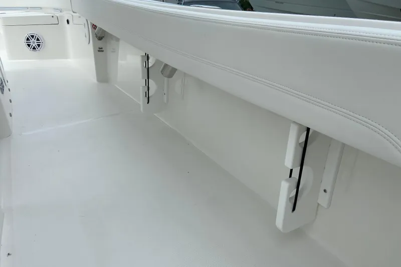 Slide: The Image of 2027 Regulator 26XO boat interior with white seating and storage compartments. - 15