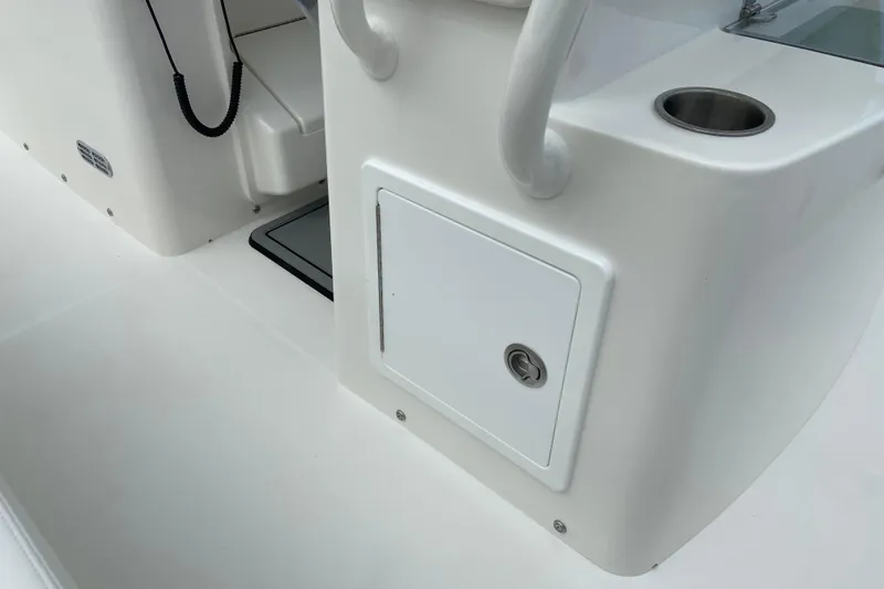 Slide: The Image of 2027 Regulator 26XO boat interior with storage compartment and cup holder. - 17