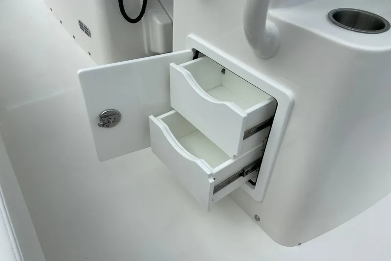 Slide: The Image of 2027 Regulator 26XO boat storage drawers, open and white, showcasing interior compartments. - 18