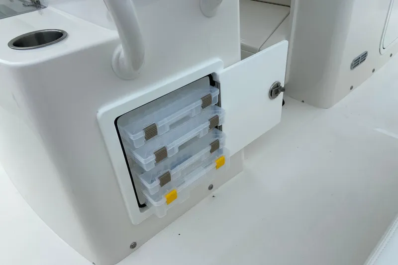 Slide: The Image of Storage compartment with tackle boxes on a 2027 Regulator 26XO boat. - 20