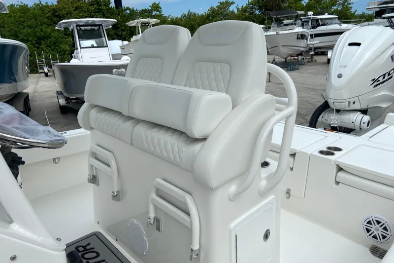 Slide: The Image of 2027 Regulator 26XO boat with white cushioned seating and Yamaha outboard engine. - 22