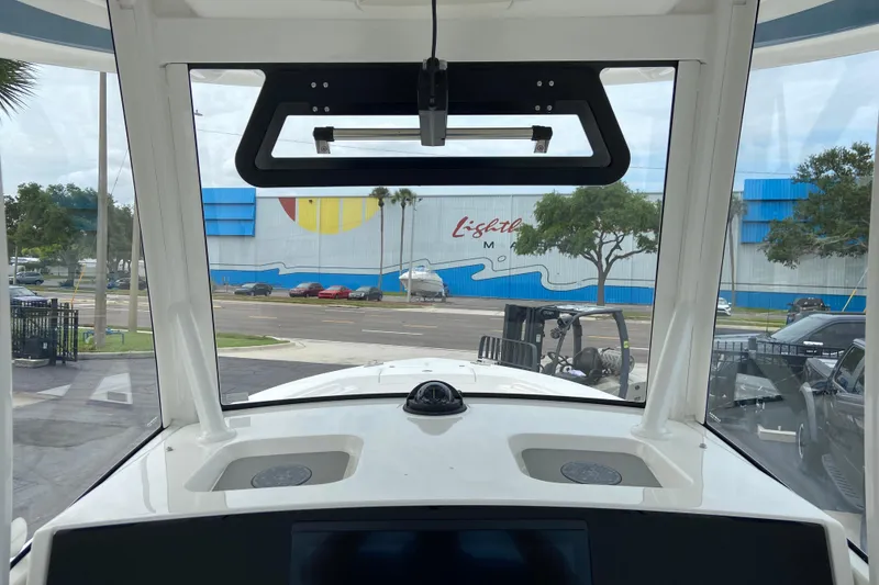 Slide: The Image of Interior view from a 2027 Regulator 26XO boat, showcasing dashboard and windshield. - 24
